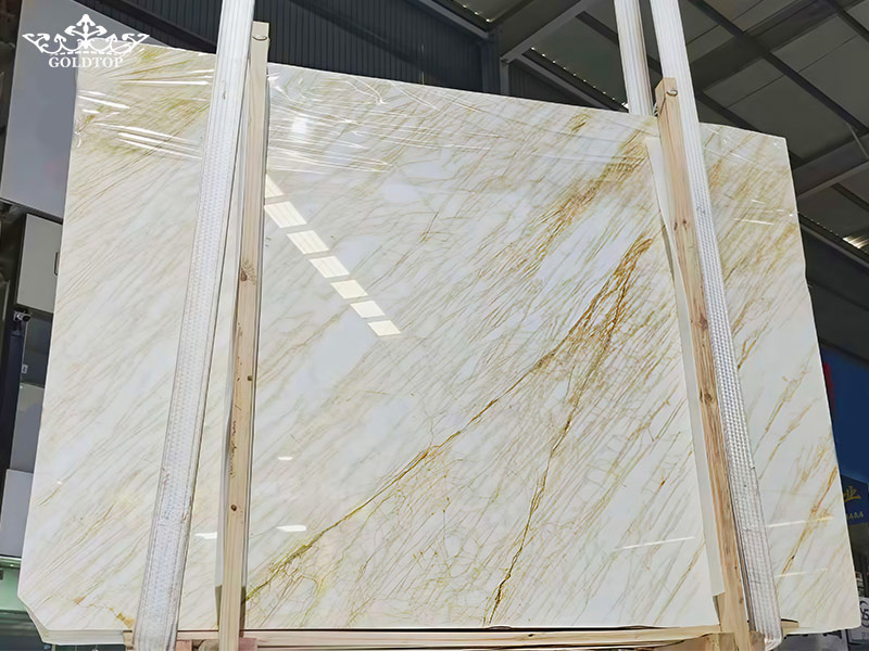 Golden Spider Marble is a natural marble from Greece, recognized for its white background and intricate golden, light brown, and reddish-brown veins. 